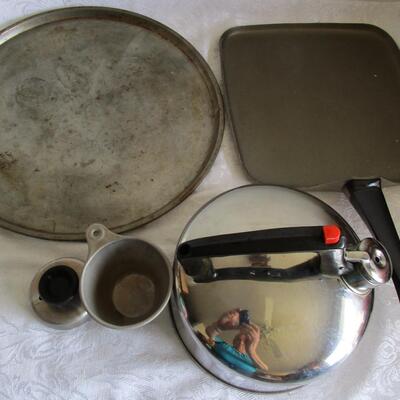 #51 Pizza pan, griddle, tea pot, measuring cup, an biscuit cutter