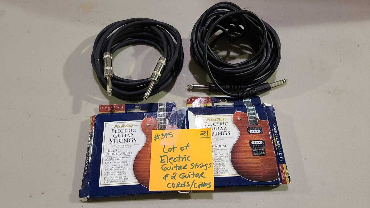 Lot of 2 Guitar Amp Cords and 2 sets of Electric Guitar Strings Item