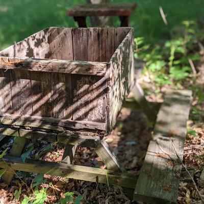 Antique picnic table, crate, and stool.
