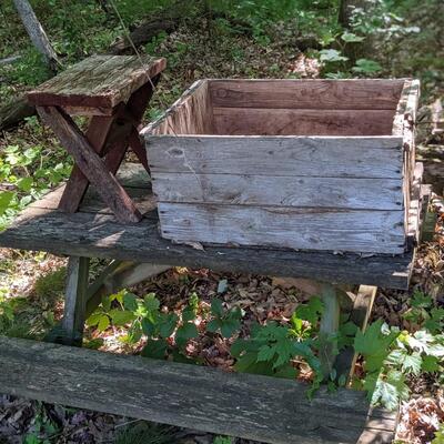 Antique picnic table, crate, and stool.