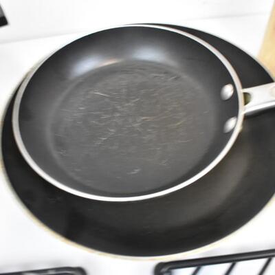 Various Kitchen Items: 2 metal trivets, flatware, 3 pans, small knife block