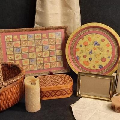 Lot 222 Large and Small Baskets, Rectangular and Round Metal Trays, 2 Pearl Table Runners, Pillar Candle, Small Candle, and 2 Gold Frames