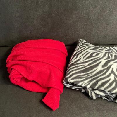 Lot 235  Back and White Snuggie and Red Snuggie 