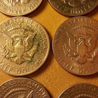 8 Kennedy half dollar coins.