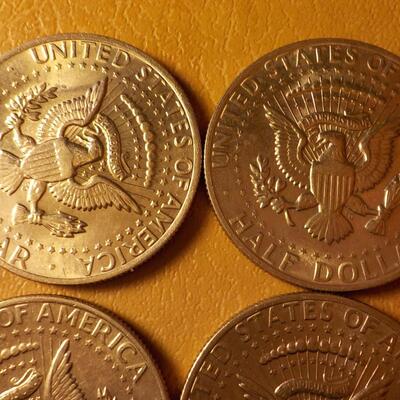 8 Kennedy half dollar coins.