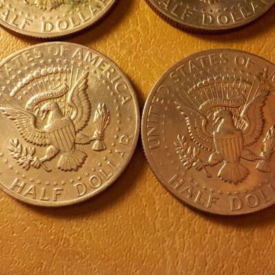 8 Kennedy half dollar coins.