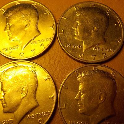 8 Kennedy half dollar coins.
