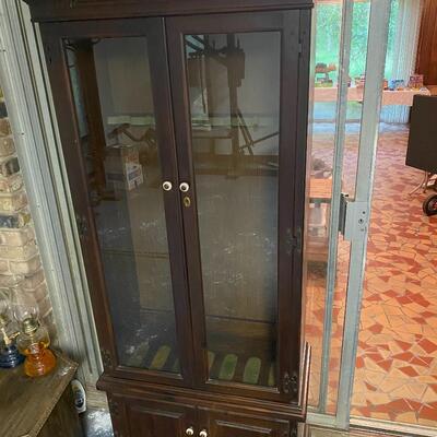 Gun cabinet with locking glass doors