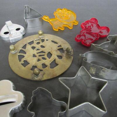 Vintage Aluminum and Plastic Cookie Cutters and Brass Trivet 