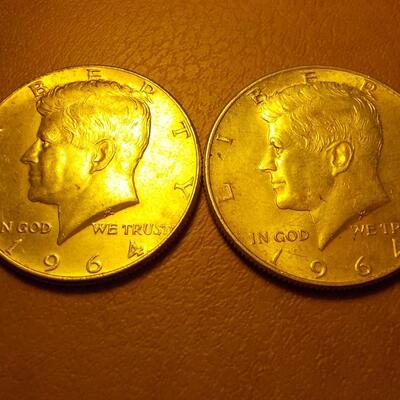 2 -1964 Kennedy half dollar coins.