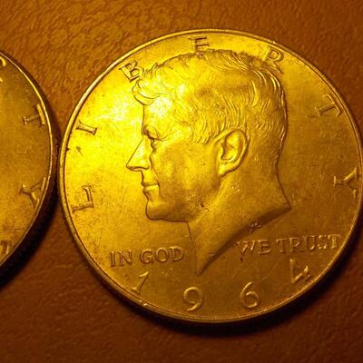 2 -1964 Kennedy half dollar coins.