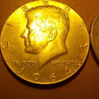 2 -1964 Kennedy half dollar coins.