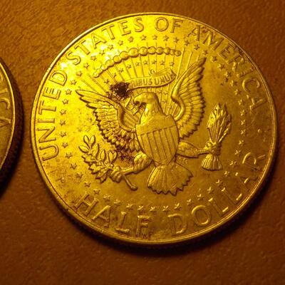 2 -1964 Kennedy half dollar coins.