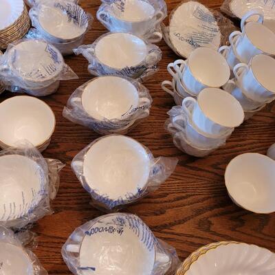 Lot 85: Wedgwood Gold Chelsea (many pieces still New in original packaging)