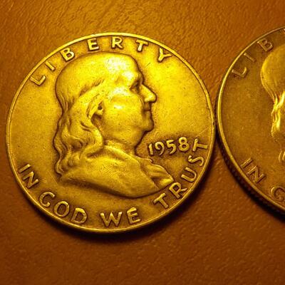 1958 and 1951 Benjamin silver half dollars.
