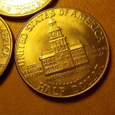 3- Kennedy centennial half dollars.