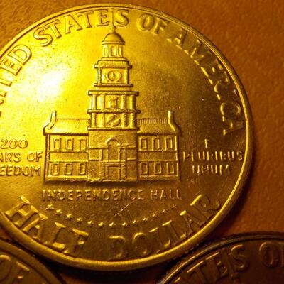3- Kennedy centennial half dollars.