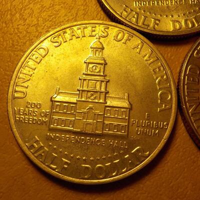 3- Kennedy centennial half dollars.