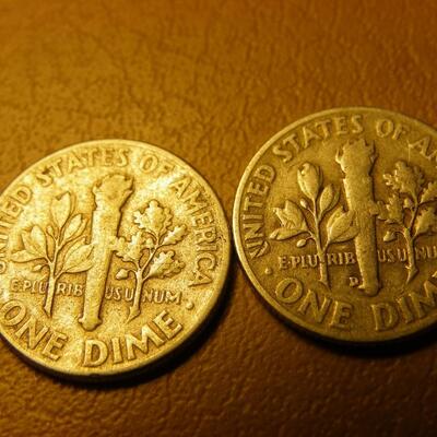 2- 1957 and 1953 Roosevelt silver dimes.