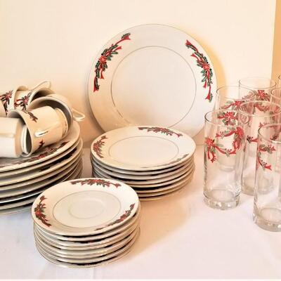 Lot #110  Set of Christmas Dinnerware in the "Poinsettia Ribbon" pattern
