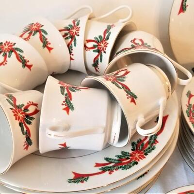 Lot #110  Set of Christmas Dinnerware in the "Poinsettia Ribbon" pattern