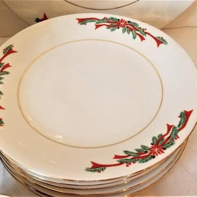 Lot #110  Set of Christmas Dinnerware in the "Poinsettia Ribbon" pattern