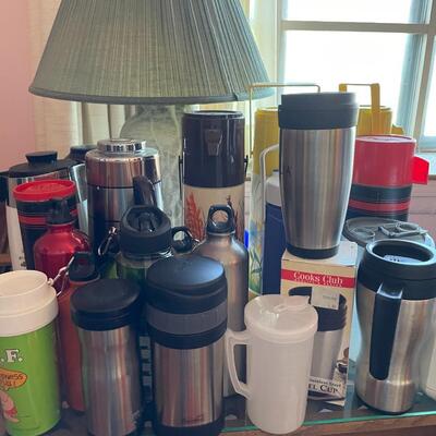 Lot 10- Wood table, lamp, misc. thermos mugs and water bottles.