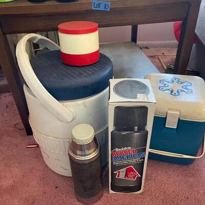 Lot 10- Wood table, lamp, misc. thermos mugs and water bottles.