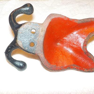 Vintage red fox cast iron hanger.
