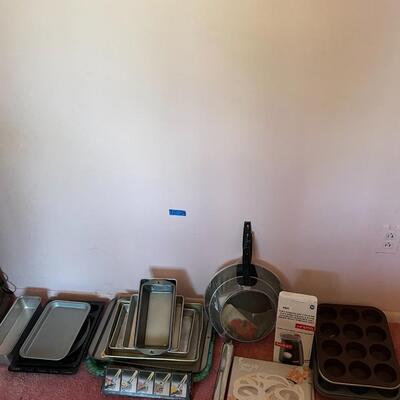 Lot 29- Misc. baking pans, pans for cooking, tongs, trivet, knife, bodum coffee grinder
