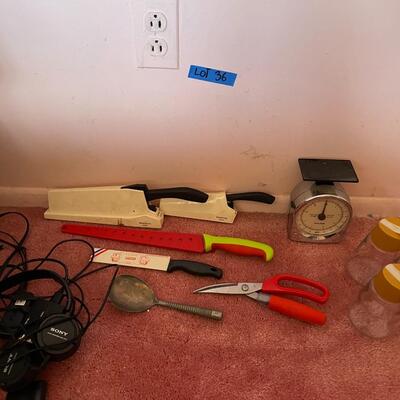 Lot 36- scale, (4) knives two come with sharpeners, scissors, (2) glass pitchers, sony headphones, spoon