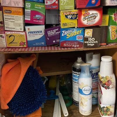 lot 44- Misc. cleaners, hand sanitizer, foil/ plastic wrap, cleaning supplies, vintage metal paper rack