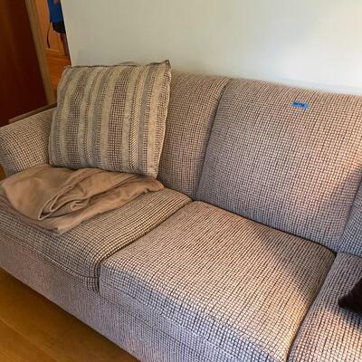 lot 138- sleeper sofa with pillows and blankets
