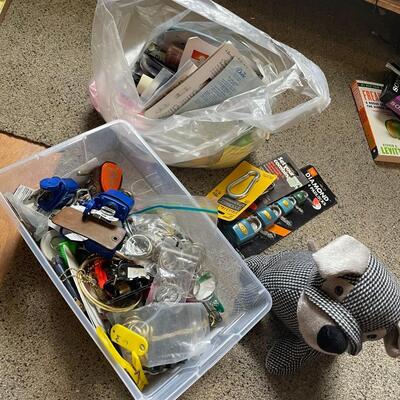 lot 230- box of misc. keys, keychains, dog door stopper, locks, bag of misc. toiletries 