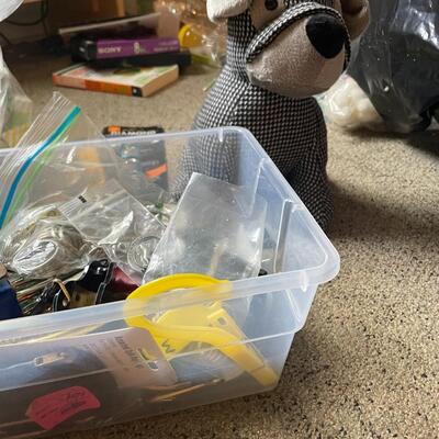 lot 230- box of misc. keys, keychains, dog door stopper, locks, bag of misc. toiletries 