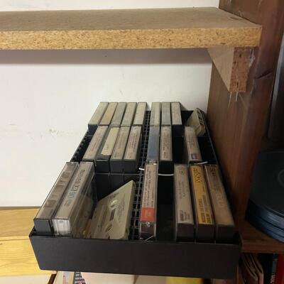 lot 249- shelves of items, books, cassettes, tools, lamps, videos circa 1950's, dell speakers, box, etc.