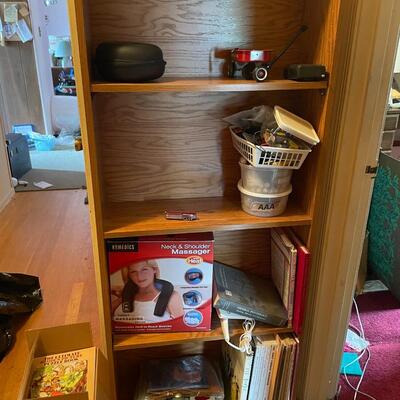 lot 267- Shelf with contents, batteries, massager, books, puzzles, pocket knife, etc.