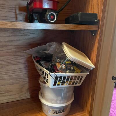 lot 267- Shelf with contents, batteries, massager, books, puzzles, pocket knife, etc.