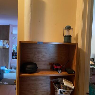 lot 267- Shelf with contents, batteries, massager, books, puzzles, pocket knife, etc.
