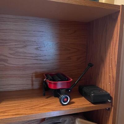 lot 267- Shelf with contents, batteries, massager, books, puzzles, pocket knife, etc.