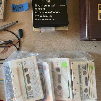 lot 295- TRS-80 buffs, digitizing pen, binders, cassettes, vintage phone, lamp, trashcan, etc.