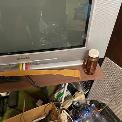 lot 326- Sony tv, table, misc. cords, tools
