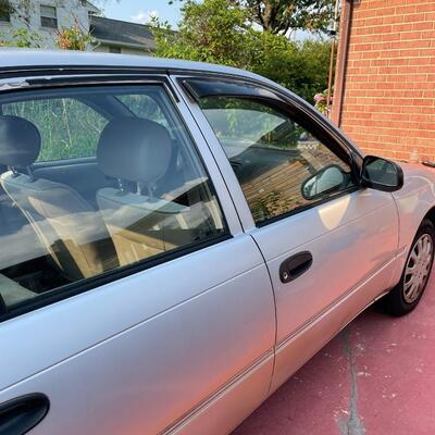 lot 353- 1997 Toyota Corolla 4s silver runs great. Title is clear and in hand!