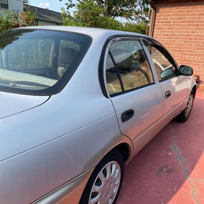 lot 353- 1997 Toyota Corolla 4s silver runs great. Title is clear and in hand!