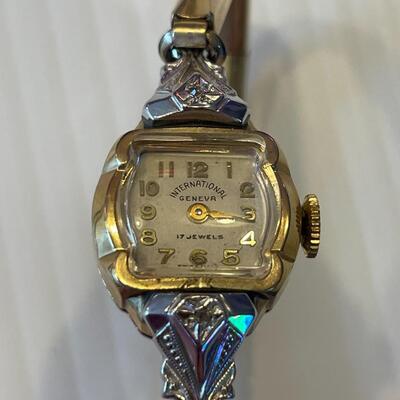 lot 358- 10K rolled gold bezel 17 ruby's and 2 diamond ruby's watch