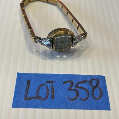 lot 358- 10K rolled gold bezel 17 ruby's and 2 diamond ruby's watch