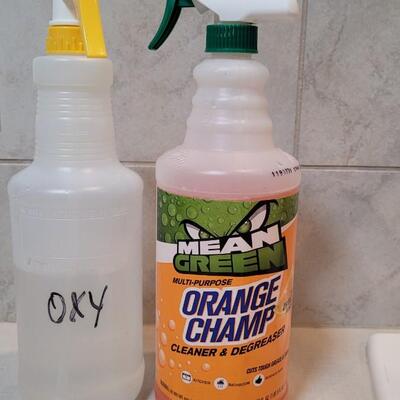 Lot 384: Orange ChampnSpray Cleaner + Clear Bottle w/ OXY? (See Line for Level)