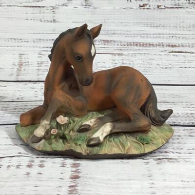 Horse laying in a Garden Ceramic Figurine 