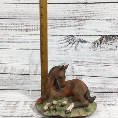 Horse laying in a Garden Ceramic Figurine 