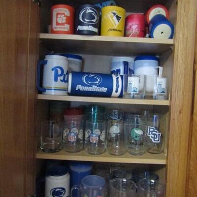 Cabinet Full of Mostly Sports Related Drinkware and Accessories